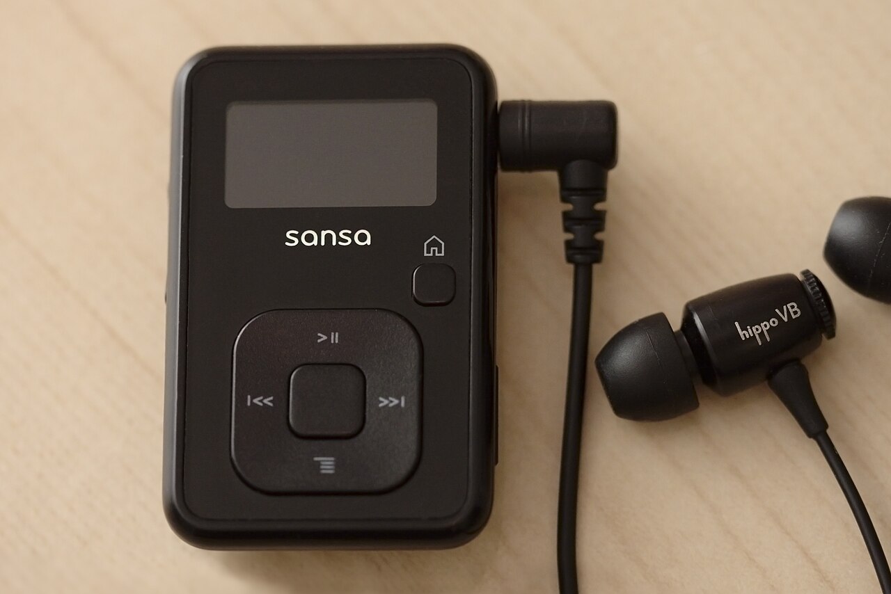 Black SanDisk Sansa Clip+ MP3 player with wired earphones